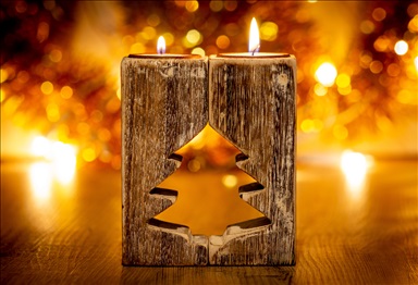 albero di natale porta candele in legno su fondo con effetto bokeh